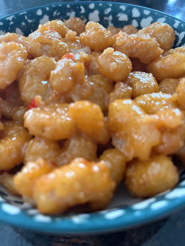 golden delicious air fryer breaded shrimp, topped with bang bang sauce