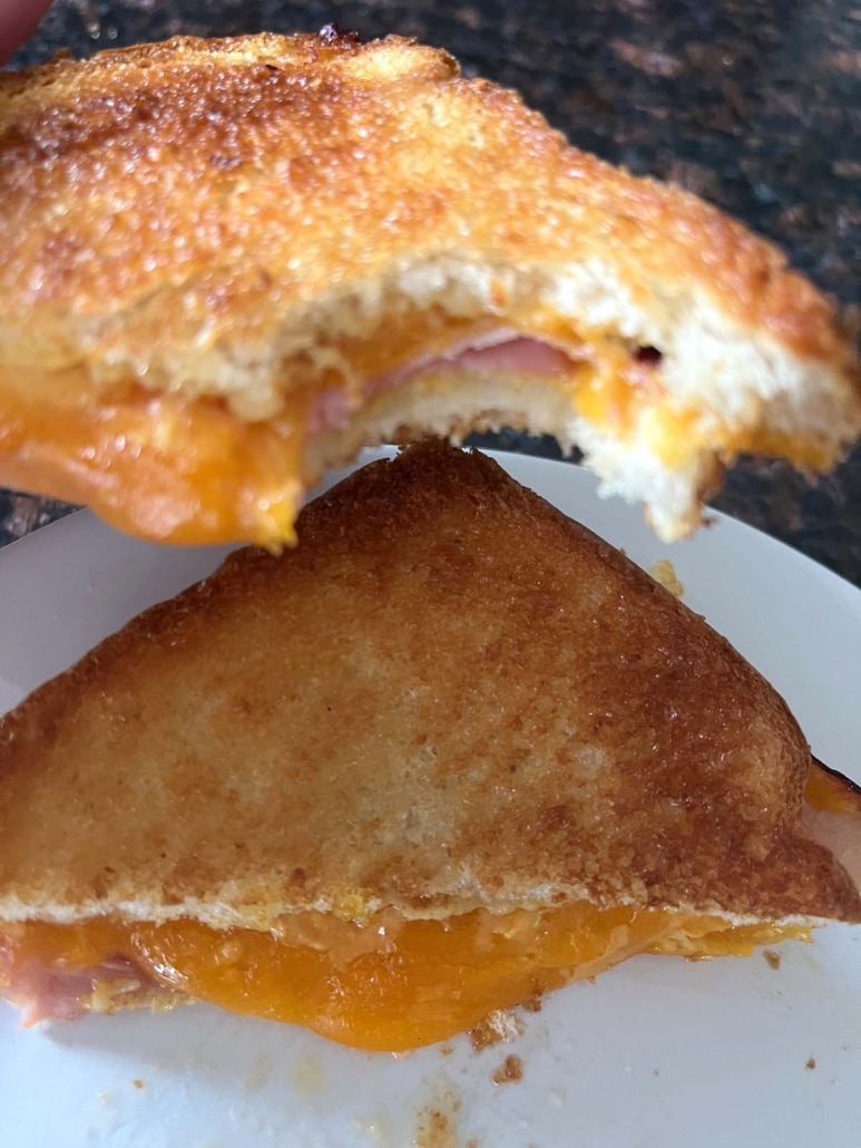 Air Fryer Grilled Ham And Cheese with a bite taken out