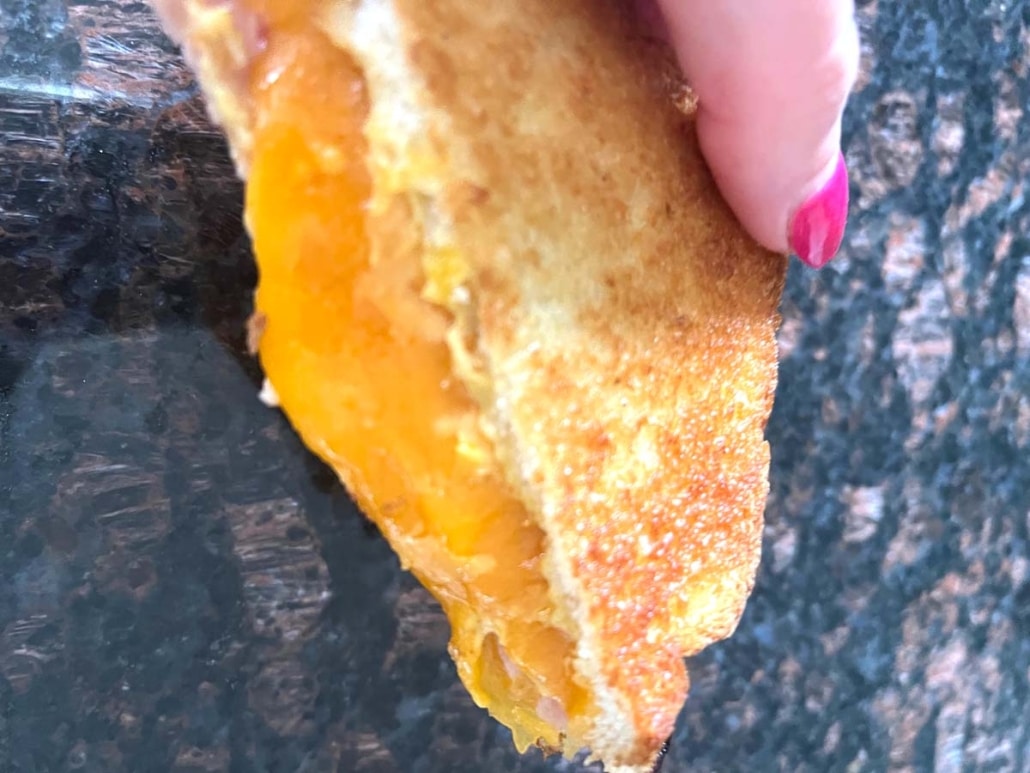 hand holding Air Fryer Grilled Ham And Cheese