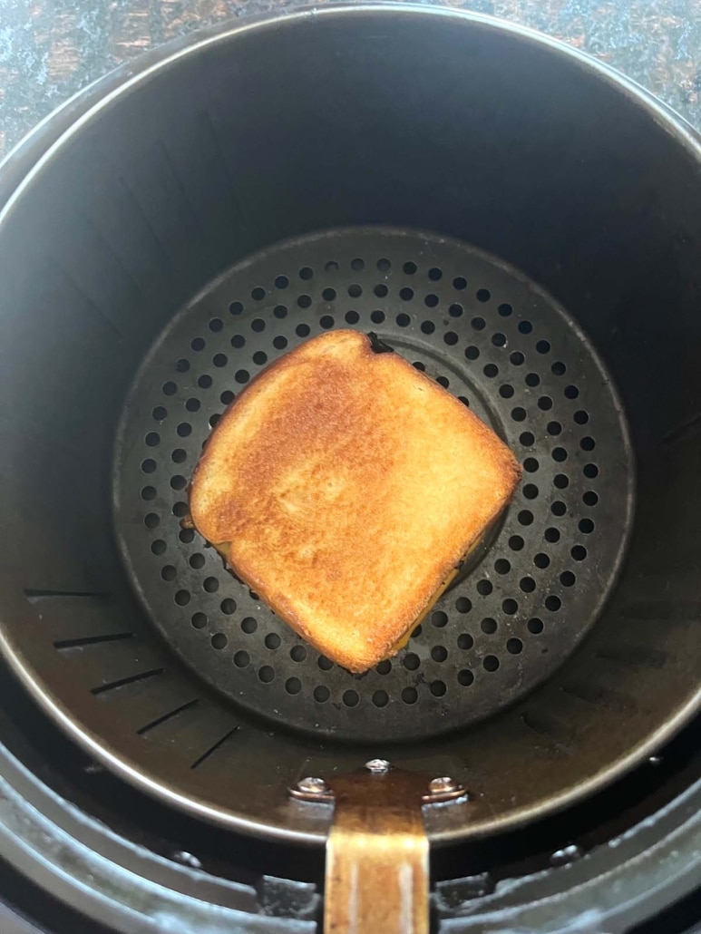 easy lunch or dinner grilled ham and cheese in the basket of an air fryer
