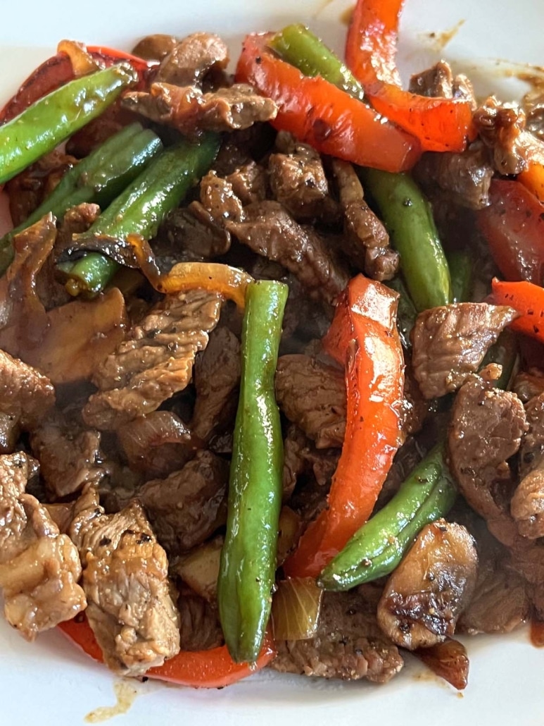 sauteéd vegetables and sirloin steak, topped with sauce