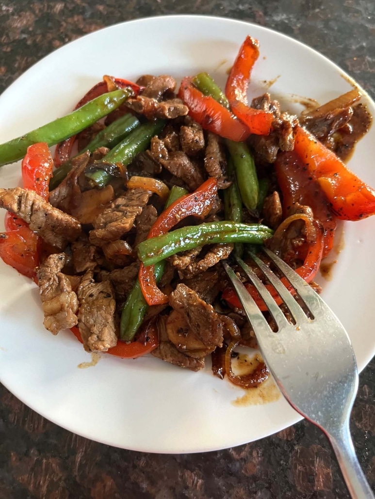 fork grabbing a bite of black pepper angus steak