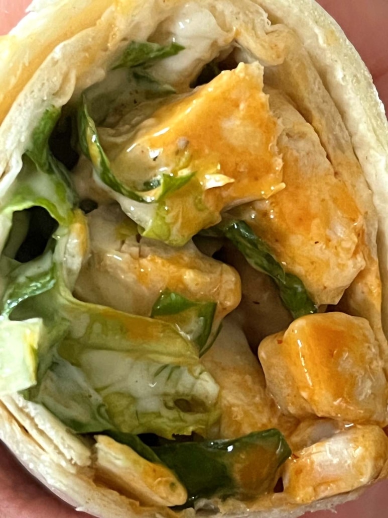 juicy chicken bites covered in buffalo sauce and topped with lettuce and ranch dressing