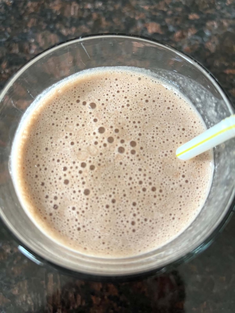 freshly blended Chocolate Banana Protein Shake with a straw in it 