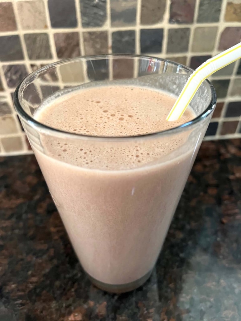 glass of Chocolate Banana Protein Shake with straw in it
