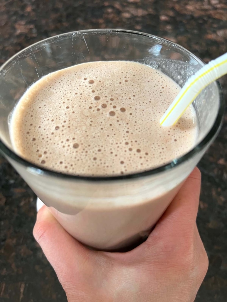 Chocolate Banana Protein Shake with straw in the cup