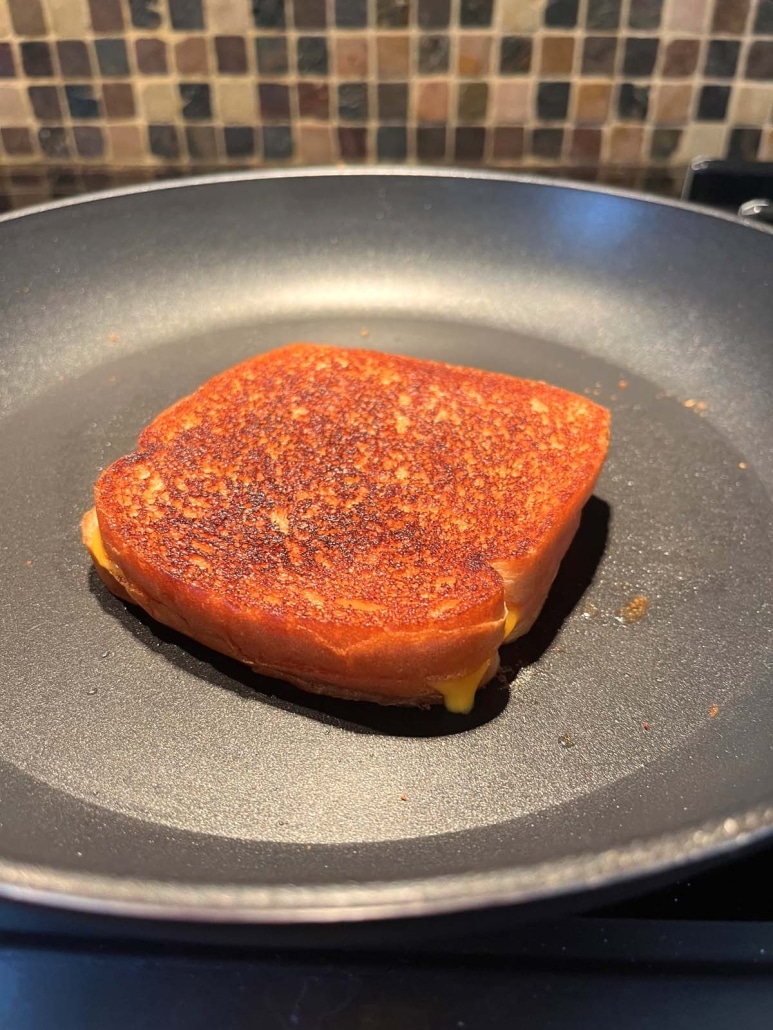 crispy breading on a Grilled Turkey And Cheese Sandwich, cooked in a skillet