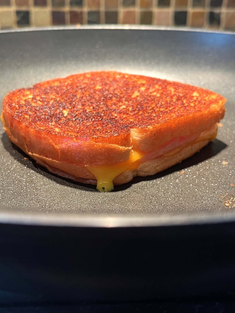 skillet with Grilled Turkey And Cheese Sandwich cooking in it