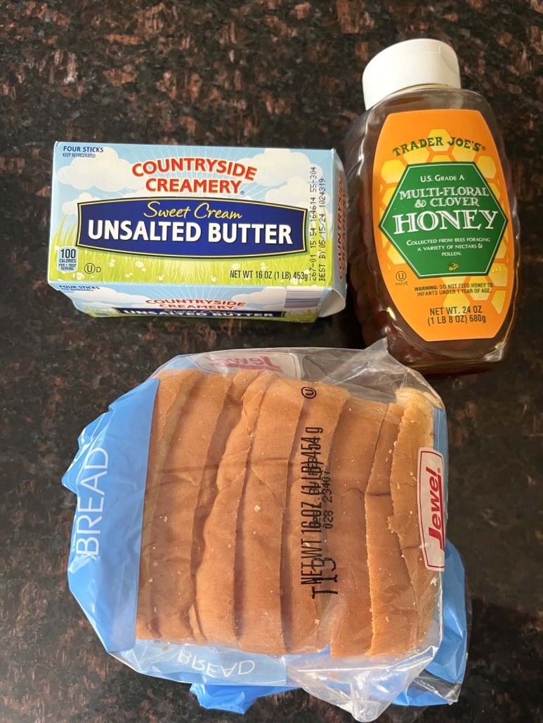 a package of bread next to a container of butter and a container of honey