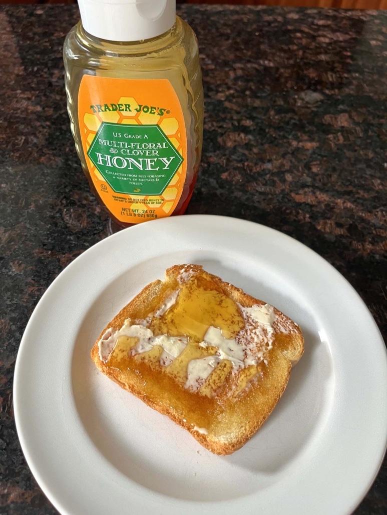a plate of Honey Toast next to a container of honey