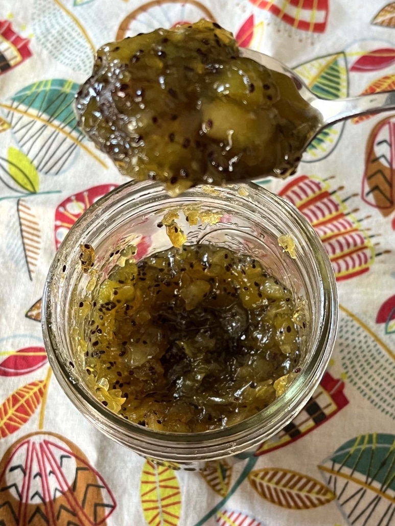 scooping up a spoonful of Kiwi Jam out of a jar