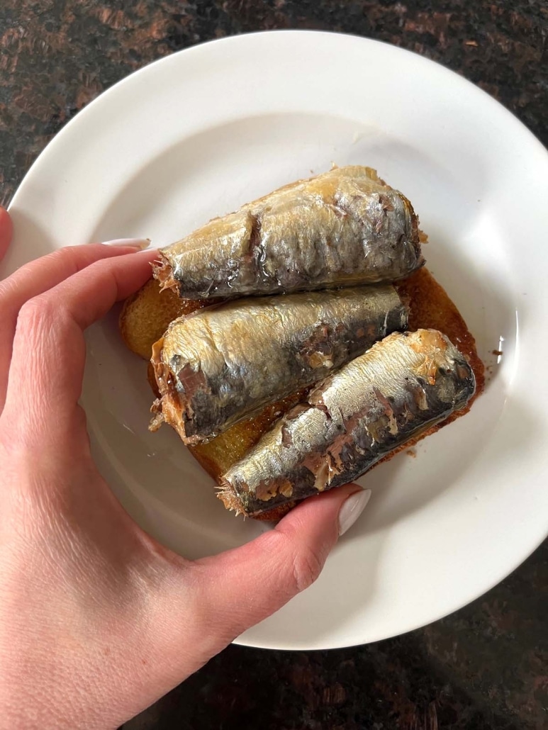 hand holding Sardine Toast
