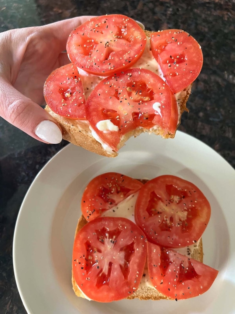 2 slices of Tomato Toast, one with a bite taken out