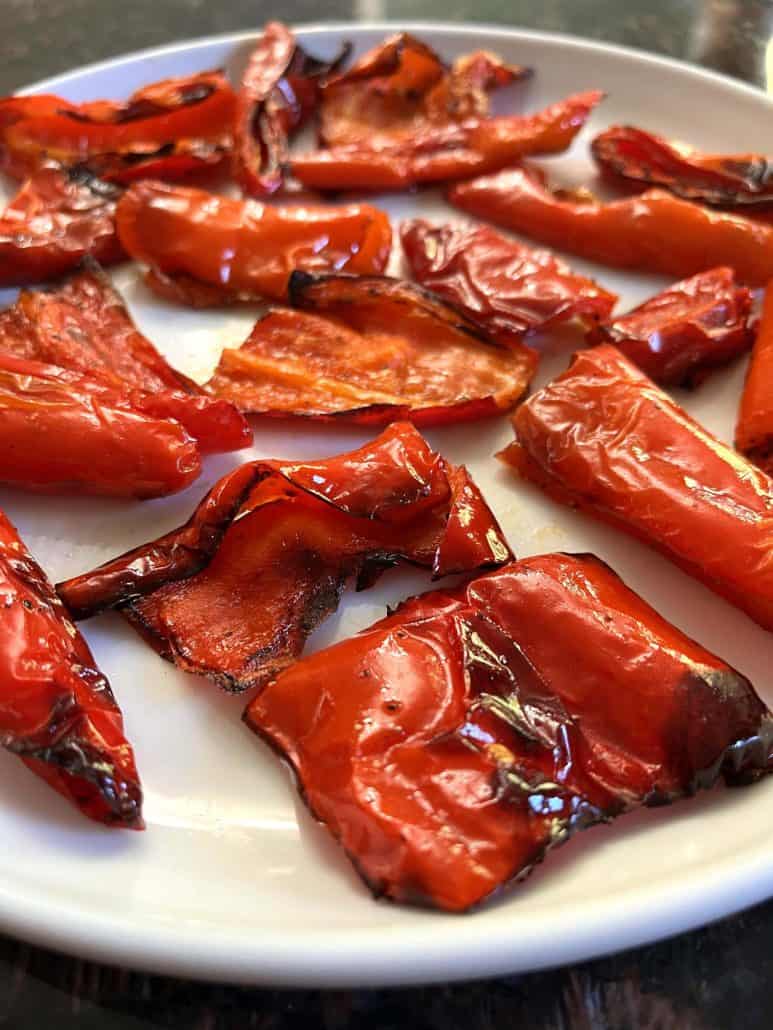 Side angle of air-fried ancient red sweet peppers, showing their glossy and crispy edges.
