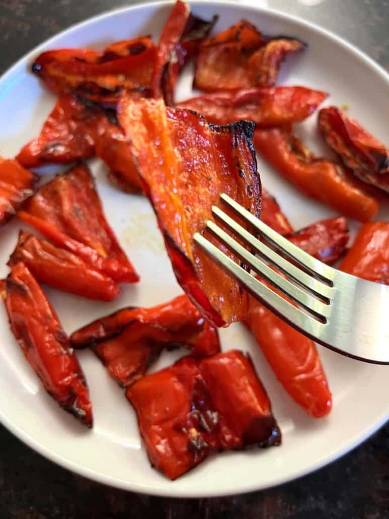Fork lifting caramelized air-fried pepper.