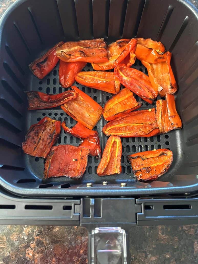 Perfectly caramelized roasted ancient red sweet peppers in the air fryer basket.