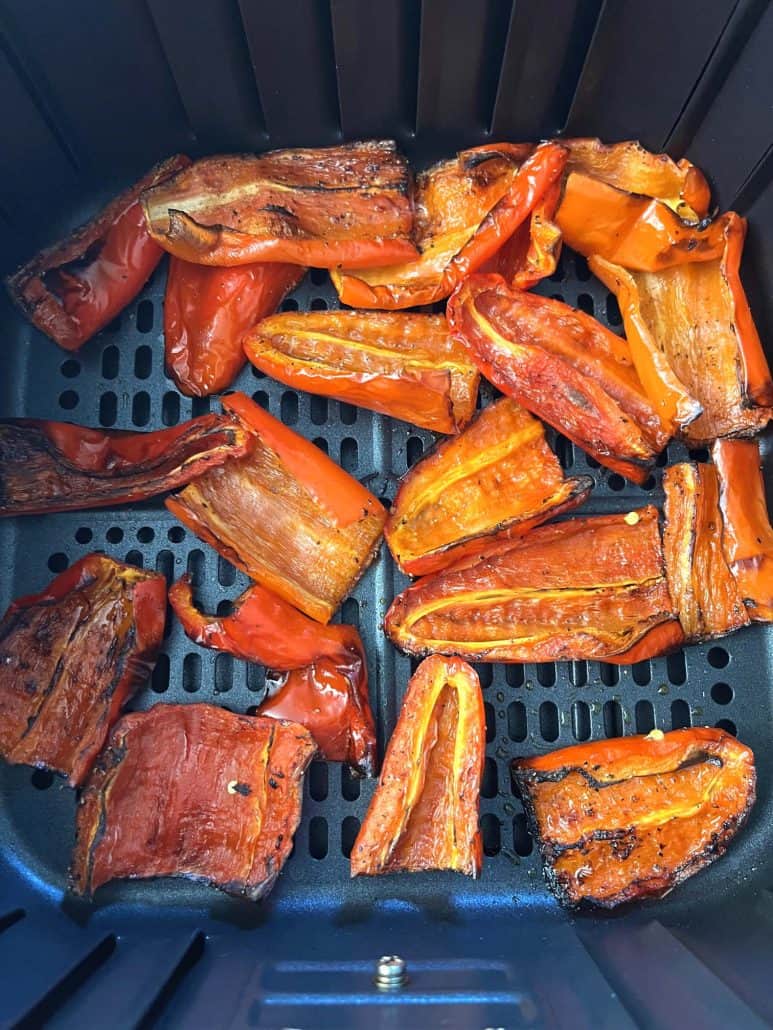 Roasted ancient red sweet peppers in the air fryer basket. ready to be serve.