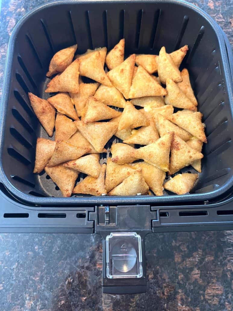 An air fryer basket filled with perfectly crisp and golden Old El Paso Stuffed Nachos, ready to serve.