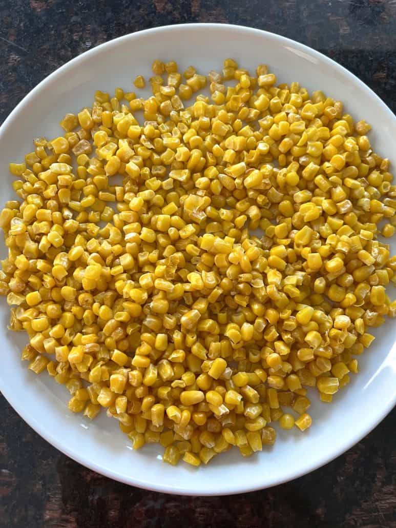 Crispy air fryer corn served on a white plate, ready to enjoy as a quick and easy side dish or snack.