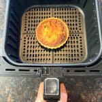 Frozen quiche cooked in air fryer basket, shown perfectly browned and ready to serve—demonstrating the easy air fryer method from the recipe.