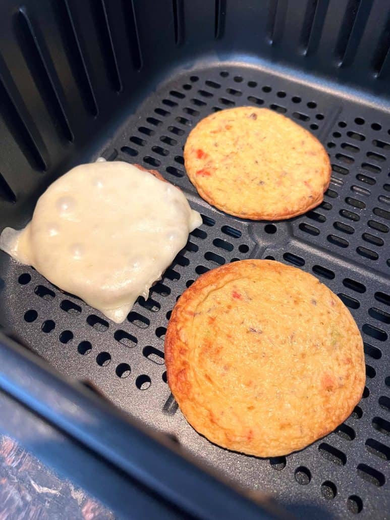 Close-up of Jimmy Dean Delights Egg’wich in the air fryer, crisping up.
