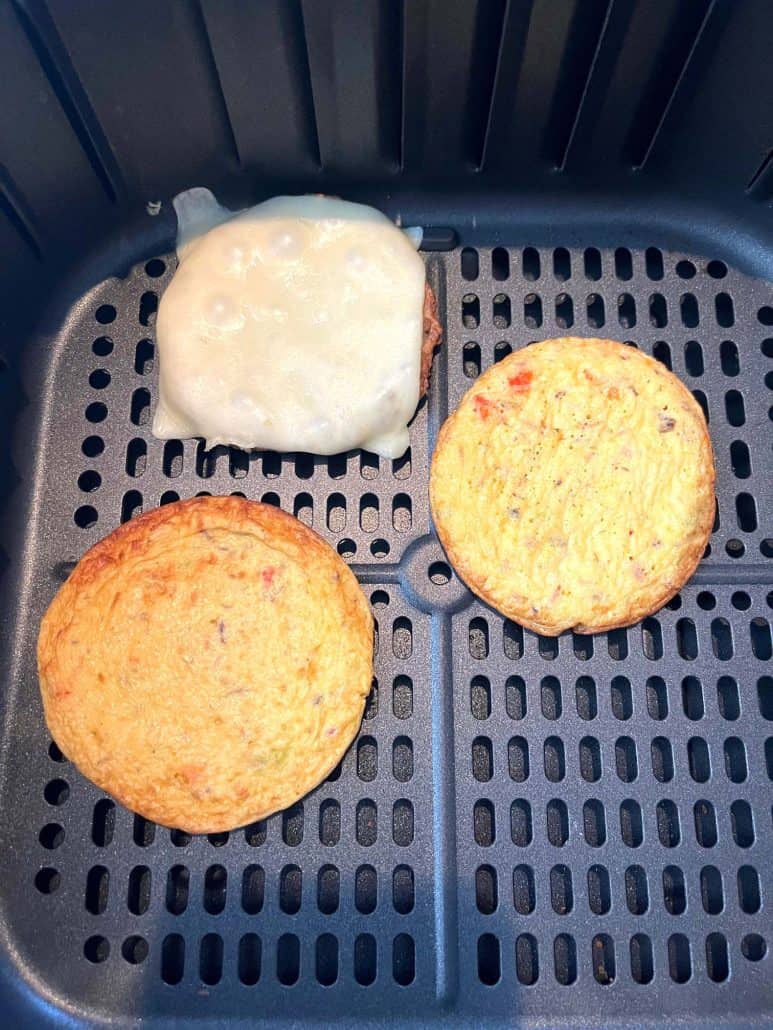 Jimmy Dean Delights Egg’wich cooking in the air fryer, separated for even heating, ensuring a crispy and perfectly cooked low-carb breakfast.
