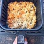 Air fryer filled with crispy, golden-brown shredded chicken breast, perfectly cooked and ready to serve as a delicious lunch or dinner.