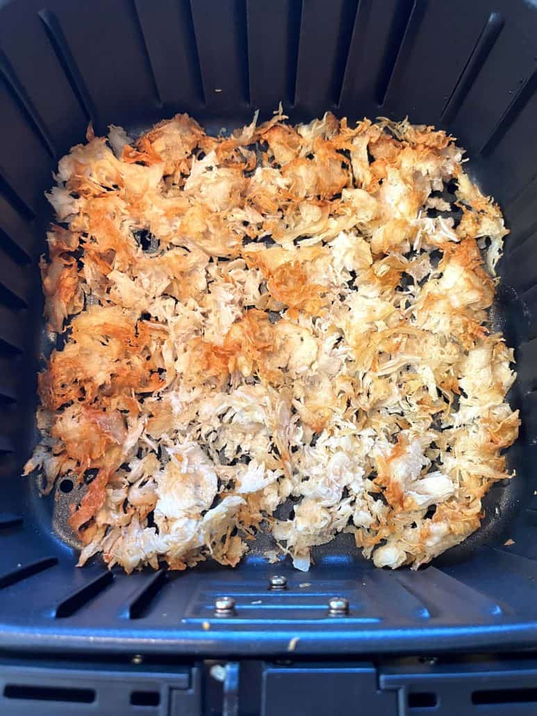 Top view of cooked shaved chicken breast in the air fryer basket—golden, crispy, and ready to serve as a quick and easy air fryer meal.