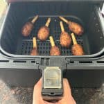 Air fryer basket filled with crispy cooked Chao Tom, showing how they look when done using the air fryer method.