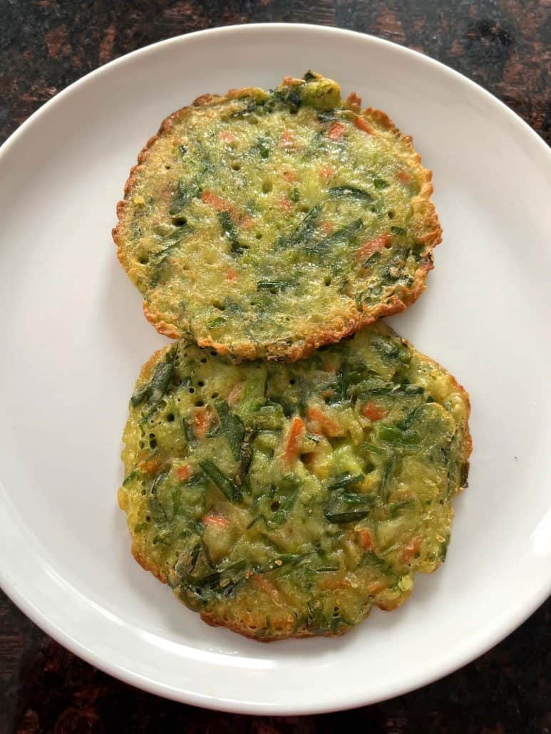 Two crispy Trader Joe’s scallion pancakes served on a white plate, ready to eat.