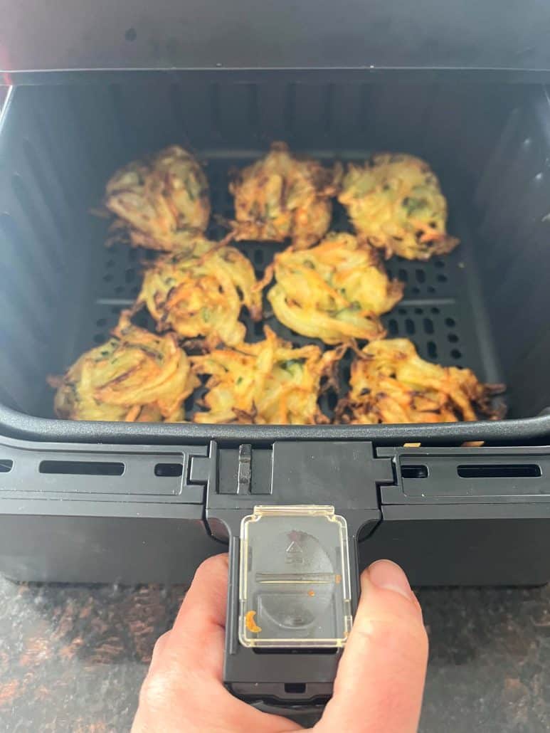 Freshly air-fried Trader Joe’s Vegetable Bird’s Nests in the air fryer basket, golden brown and crispy.