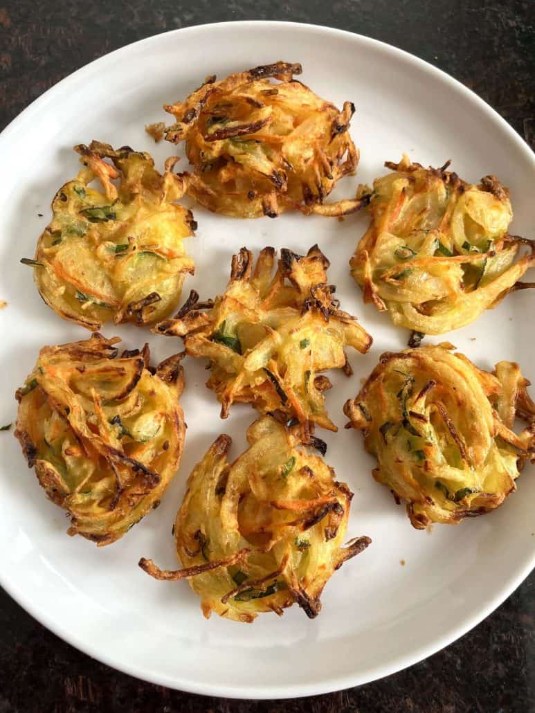 A plate of crispy, golden-brown Trader Joe’s Vegetable Bird’s Nests, freshly cooked and ready to enjoy.