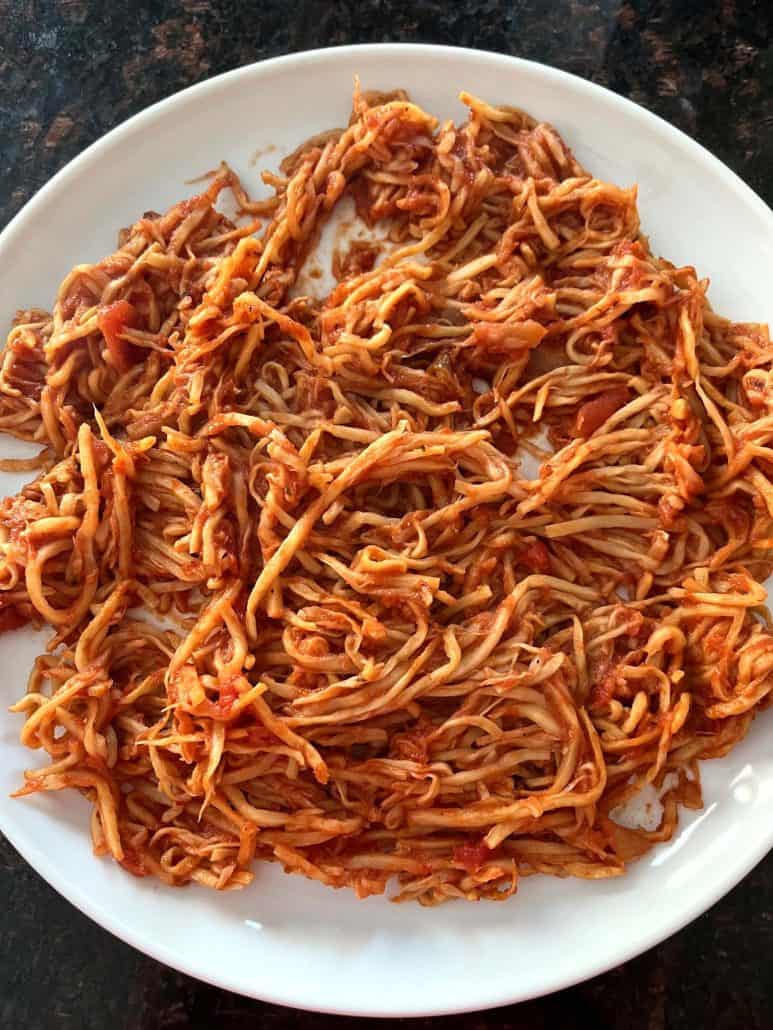 A plate filled with hearts of palm pasta coated in marinara sauce, showcasing its texture as a delicious low-carb pasta alternative.