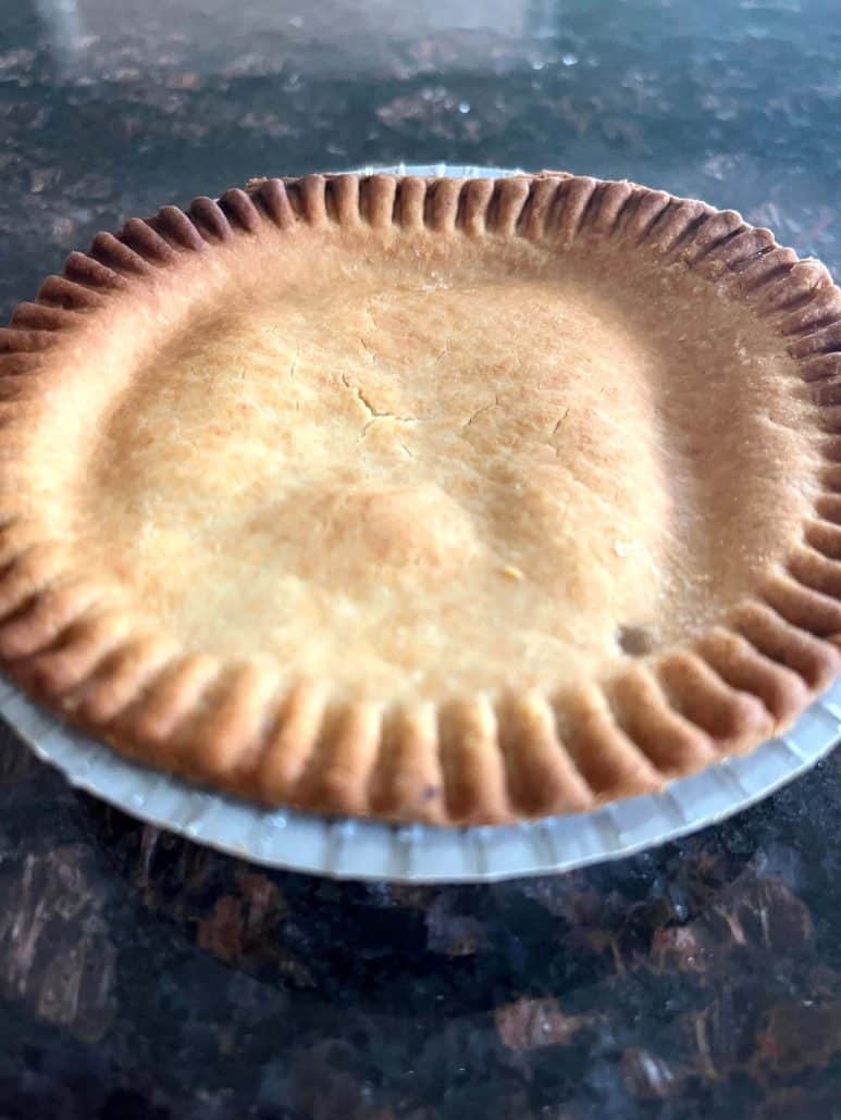 Close-up of a golden brown turkey pot pie cooked in the air fryer, showing crispy, flaky crust.