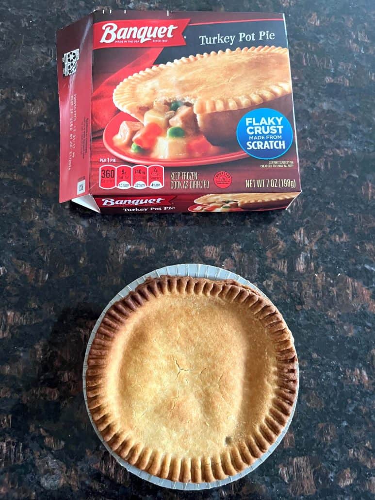 Cooked Banquet turkey pot pie on a counter with its box in the background, showing the finished air fryer result.
