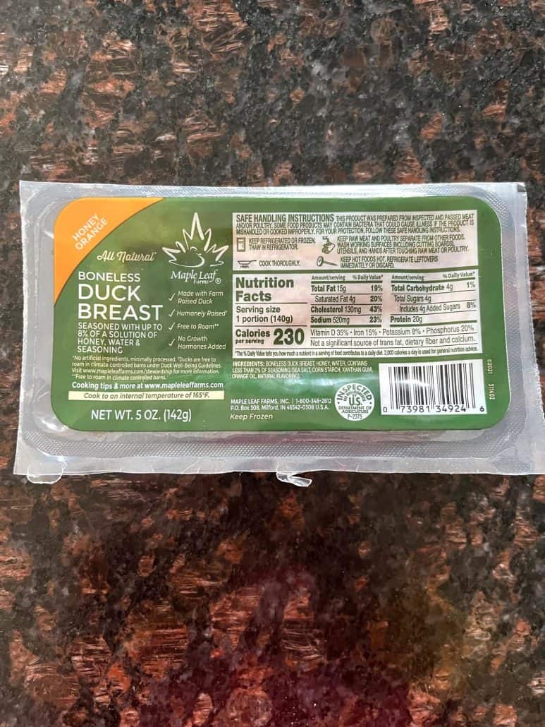 Packaged frozen duck breast on a kitchen counter before cooking, used in the Air Fryer Duck Breast recipe.