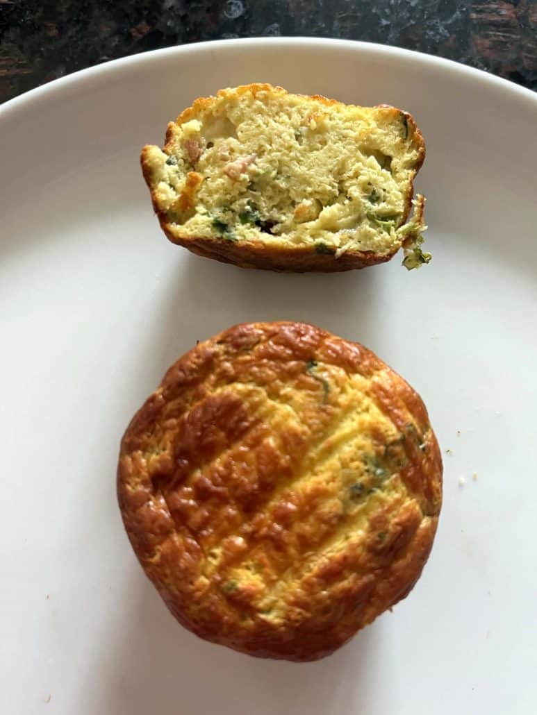 A cooked Jimmy Dean frittata cut in half on a plate, showing the fluffy inside, alongside a whole frittata, both air fried to golden brown perfection.