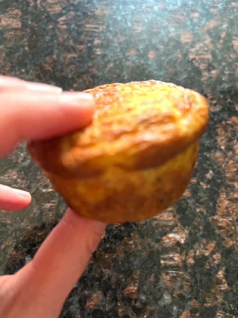 Melanie Mendelson from melaniecooks.com holding a perfectly cooked Jimmy Dean frittata, showing its golden brown edges.