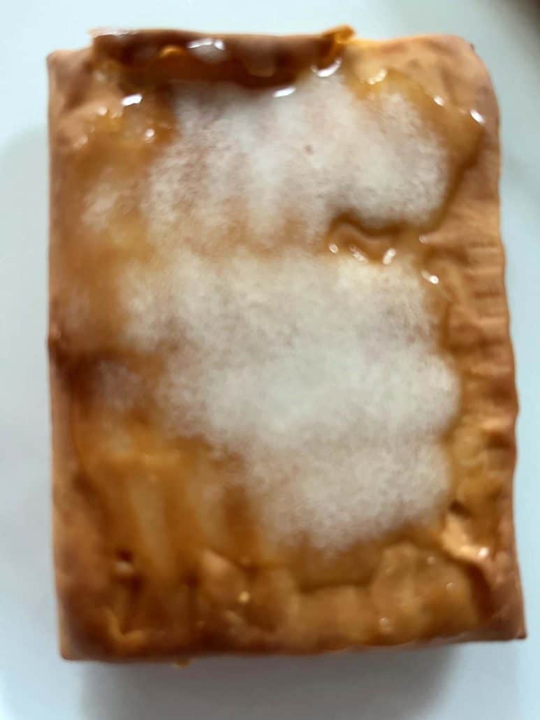 Close-up of a frosted Pillsbury Toaster Donut Pastry, showing the crispy, golden texture and sweet icing from this quick air fryer treat.