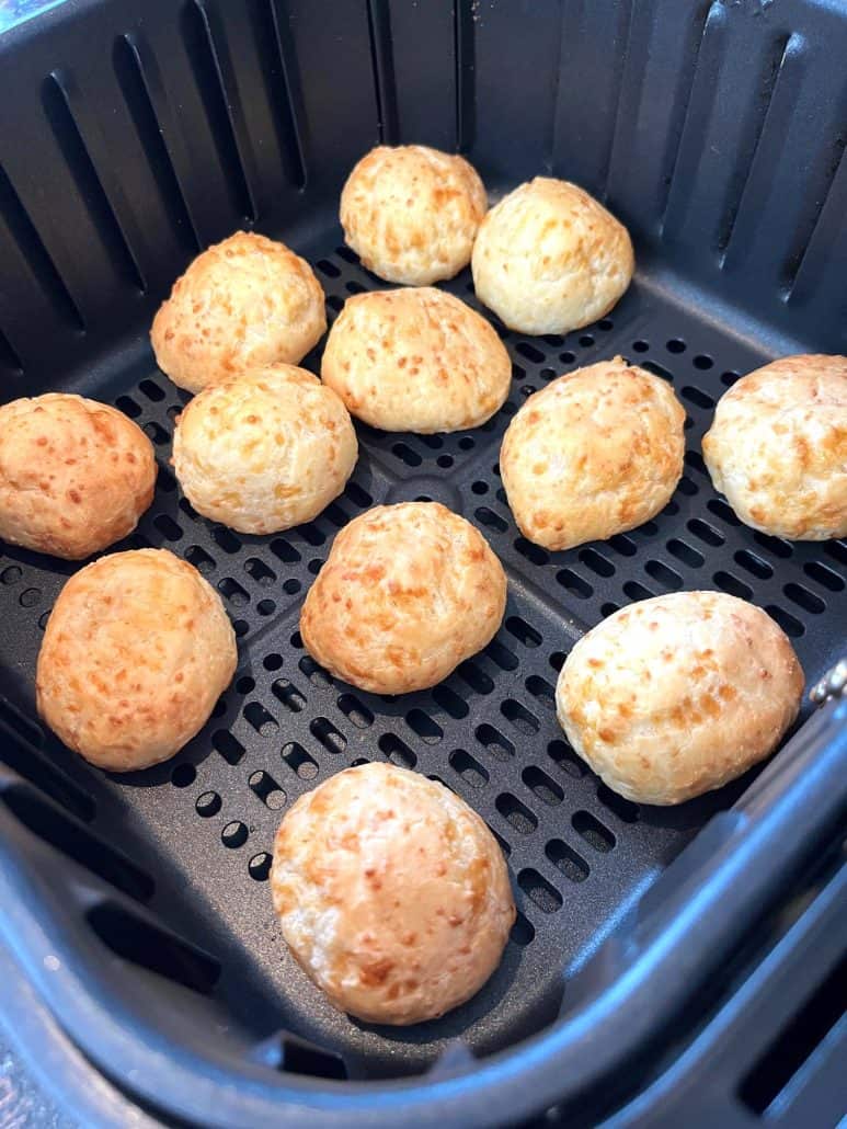 Golden brown Brazilian cheese bread cooked in the air fryer—showing their perfectly crispy exterior and ready to enjoy.