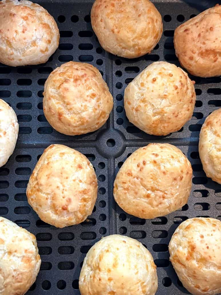 Close-up of perfectly cooked Brazilian cheese bread in the air fryer—highlighting their golden, crispy exterior from this easy air fryer recipe.