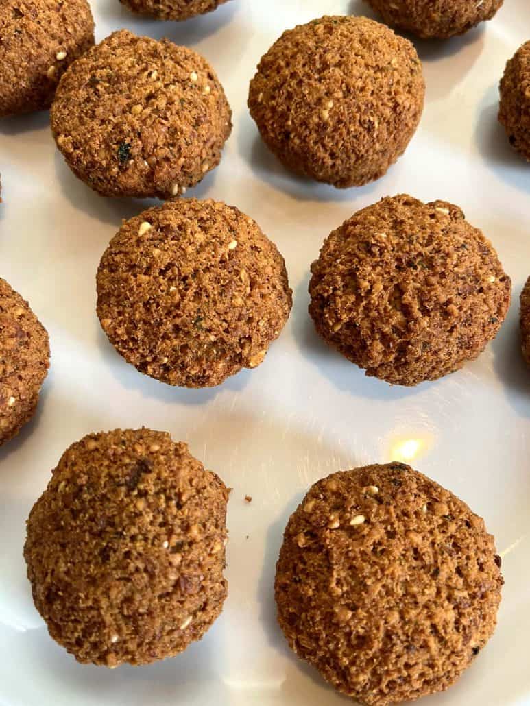 Close-up of crispy, golden brown Trader Joe’s Frozen Falafel served on a white plate, ready to enjoy with your favorite dips or in a pita wrap.