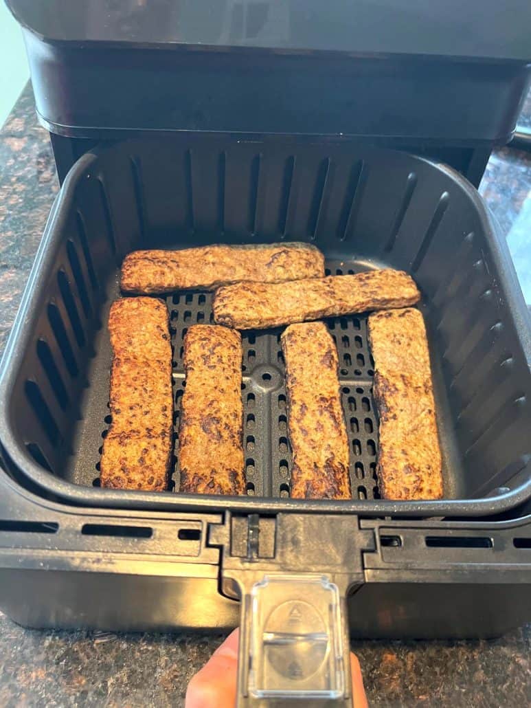 Trader Joe’s frozen beef kabobs arranged in a single layer inside the air fryer basket, ready to be cooked.