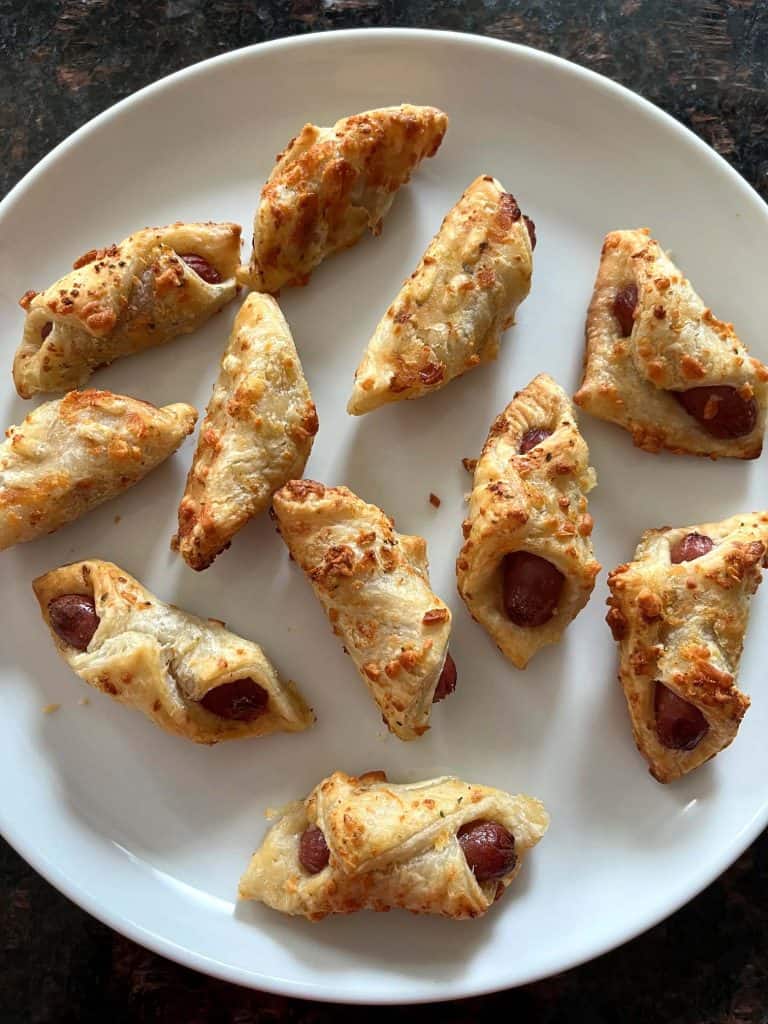 Plate of crispy, golden brown Trader Joe's Pastry Pups cooked in the air fryer, ready to serve as a quick and easy appetizer.
