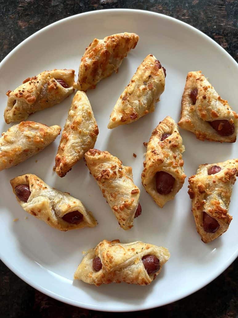 Plate of crispy, golden brown Trader Joe's Pastry Pups cooked in the air fryer, ready to serve as a quick and easy appetizer.