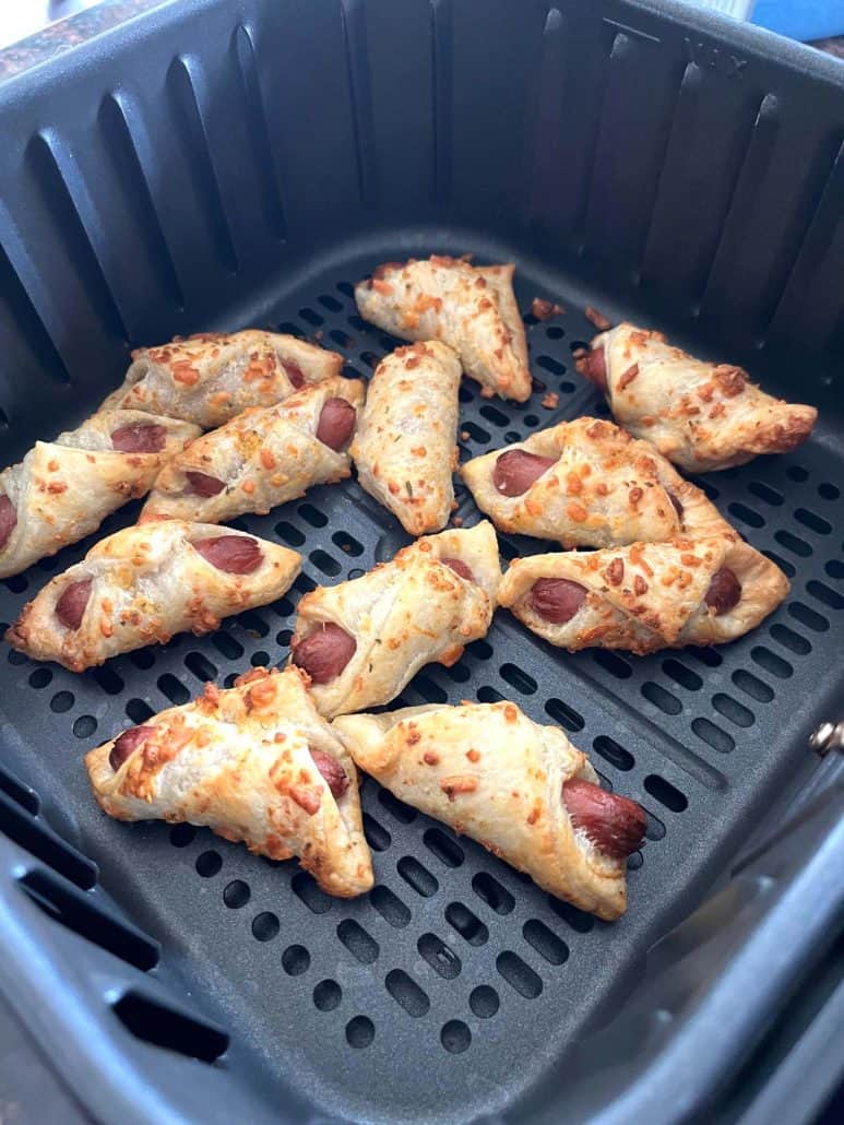 Crispy, golden brown Trader Joe's Pastry Pups freshly cooked in the air fryer basket.