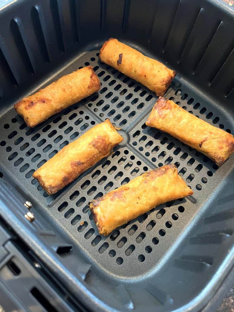 Perfectly crispy Trader Joe’s Chicken Spring Rolls inside the air fryer basket—cooked straight from frozen for a golden brown finish.