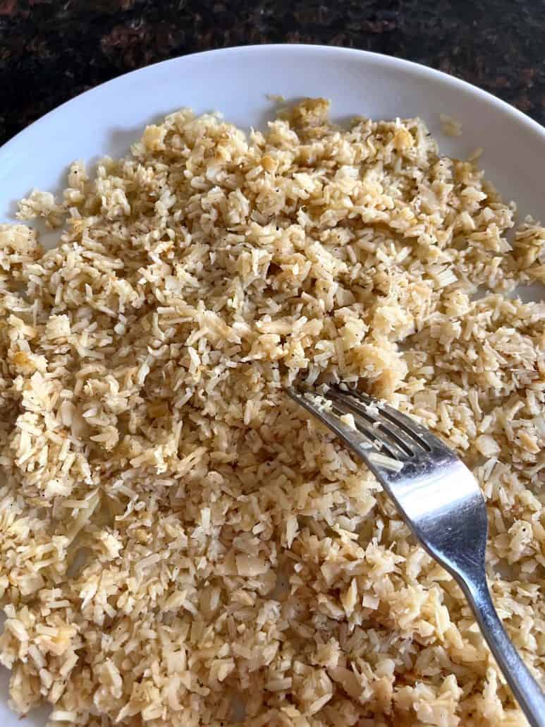 Forkful of hearts of palm rice lifted from a plate – a light and flavorful low-carb side dish ready to enjoy.