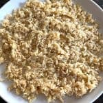 Cooked hearts of palm rice on a white plate – a low-carb, keto-friendly rice alternative that's quick and easy to make on the stovetop.