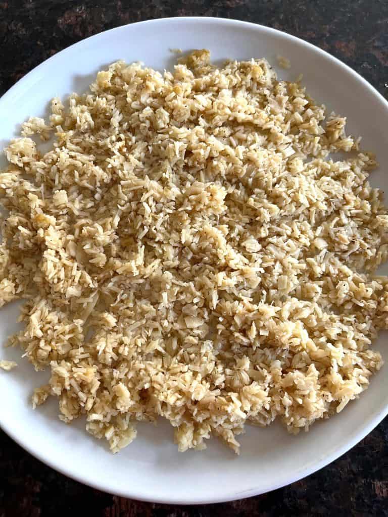 Cooked hearts of palm rice on a white plate – a low-carb, keto-friendly rice alternative that's quick and easy to make on the stovetop.